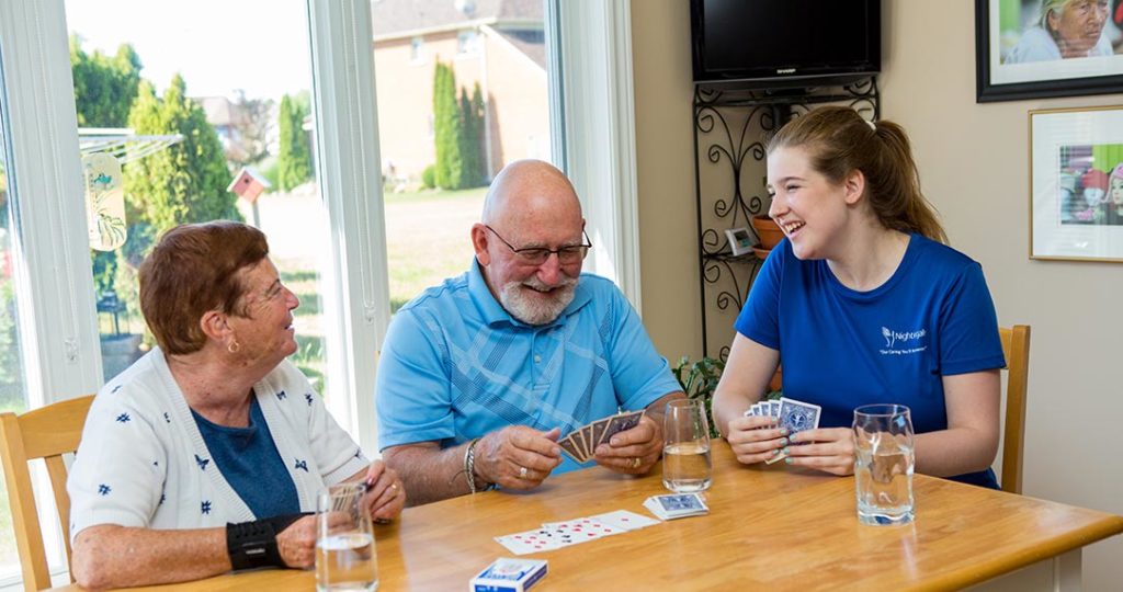 Three people playing cards