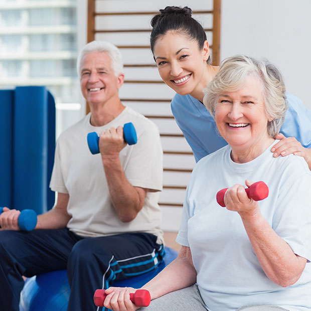 elderly couple lifitng weights